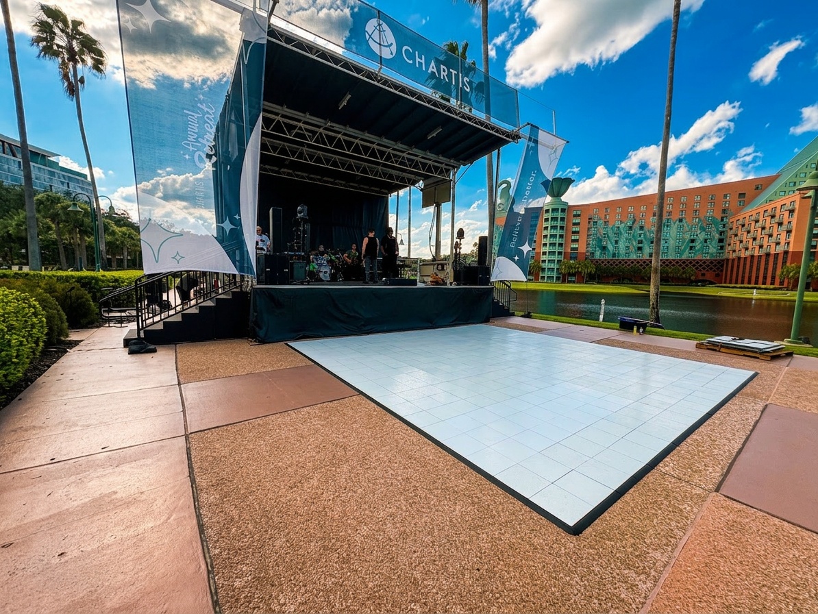 black stage decking under direct sun with heat shimmer visible, Central Florida outdoor event