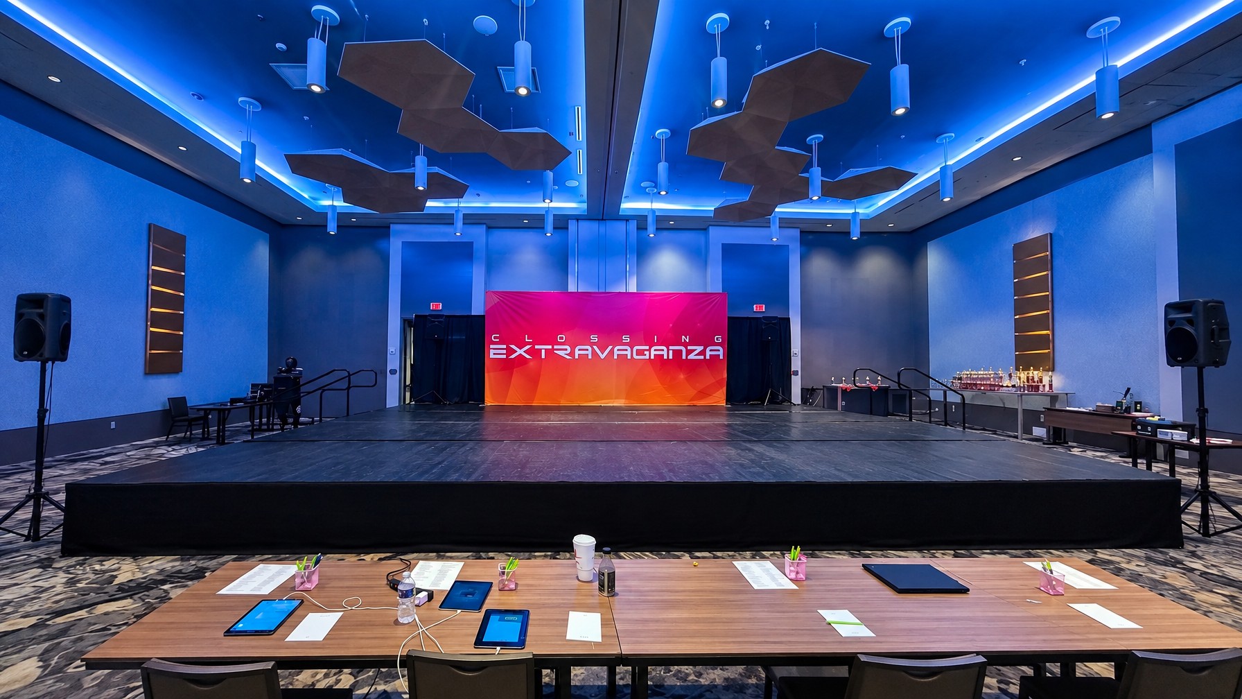 rectangular corporate stage with elevated reveal platform and branded backdrop, Central Florida event