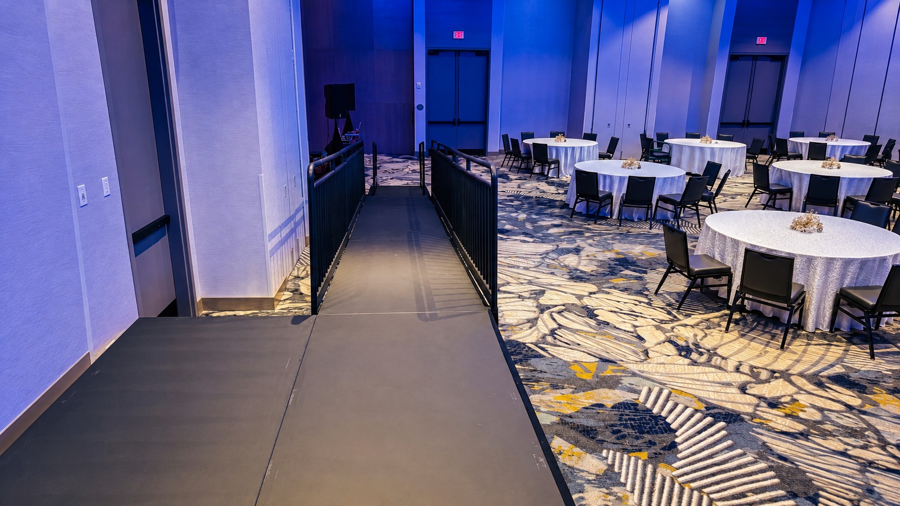 ADA-compliant ramp and guard rail setup on an elevated stage deck