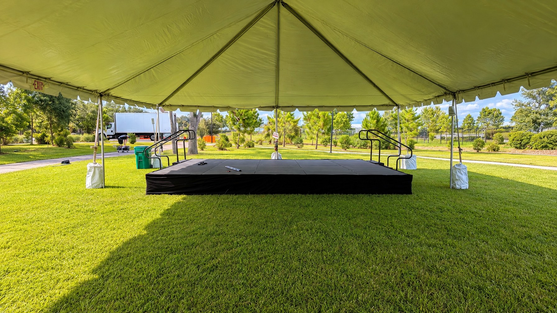 covered outdoor stage setup under late-summer storm clouds, September 2026, Orlando area